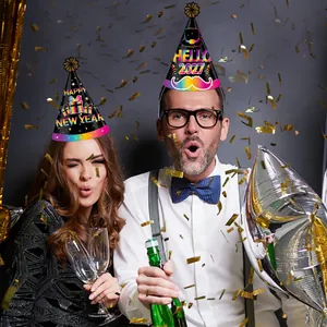 People wearing 2027 New Year party paper hats with festive confetti background