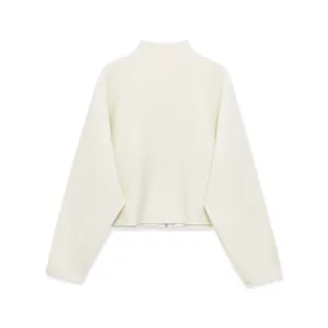 Detail view of cream knit sweater with stand collar, ribbed texture and zipper closure