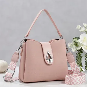 Elegant dusty pink bucket bag with geometric wide strap and silver teardrop lock