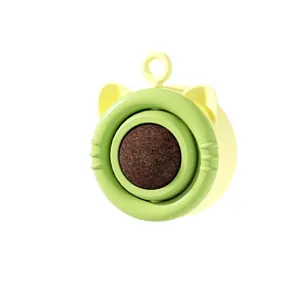Green catnip ball toy with cute cat-shaped frame and rotating ball for feline dental health
