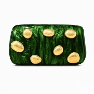 Detailed macro view of green marble acrylic clutch with gold pebble ornaments