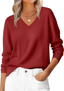 Detail of dark red V-neck knit sweater featuring ribbed cuffs and soft texture