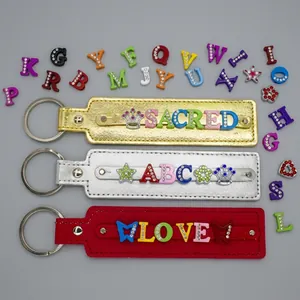 DIY sequin keychain detail showing leather straps with custom rhinestone letter sliders