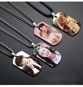 Detailed close-up of custom photo-engraved stainless steel dog tag necklaces for couples