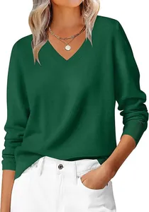 Detail of ribbed V-neckline and dark green knit texture on a soft casual sweater