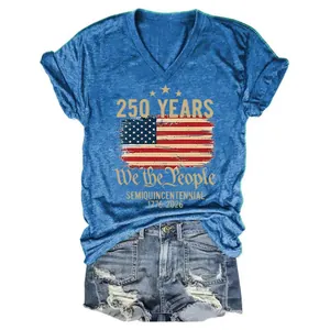 Detailed flat lay of blue V-neck T-shirt with 250th anniversary print and ripped denim shorts