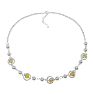 Macro view of adjustable silver steel chain with yellow cat eye beads and lobster clasp