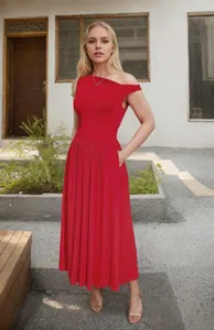 Detail view of the red one-shoulder maxi dress featuring side pockets and pleated hem