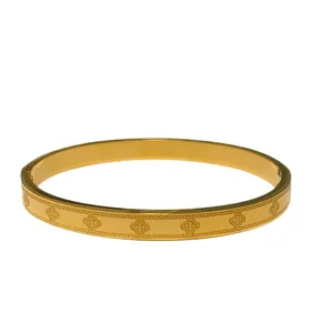 Minimalist gold titanium steel bangle featuring lucky clover pattern and beaded edges