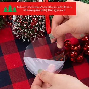 Detailed view of removing protective film from a clear acrylic Christmas ornament