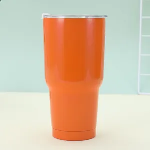 Close-up of a 30oz orange stainless steel insulated travel mug with transparent lid