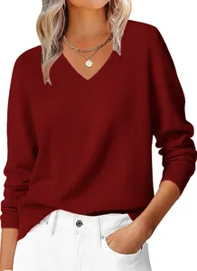 Close-up of burgundy V-neck sweater showing ribbed cuffs and fine knit texture details