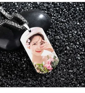 Custom silver military tag pendant featuring a color photo on black pebble background