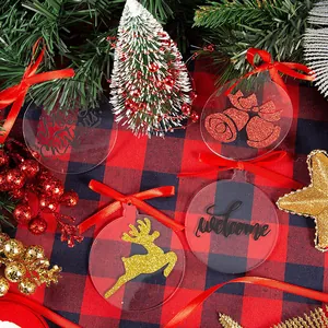 Transparent acrylic Christmas ornaments set with red ribbons and festive patterns