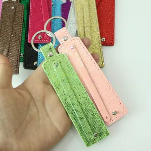 Close-up of colorful glitter sequin keychains with metal rings for DIY accessories