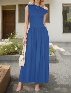 Detail view of royal blue asymmetric neck maxi dress with pleated skirt and waist seam