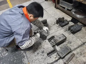 Detailed view of industrial metal cold stamping mold with pins and guide posts