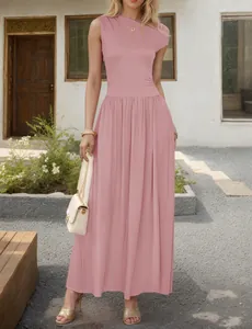 Detailed view of pink sleeveless maxi dress with pleated texture and flowy hem