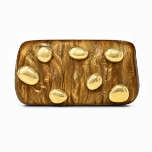 Detail of rectangular resin evening clutch with brown marble texture and gold metal accents