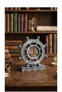 Nautical ship wheel with sailboat relief on a vintage wooden desk background