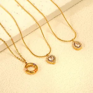 Detailed close-up of gold necklaces with zircon heart, water drop, and enamel flower charms