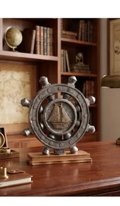 Detail of nautical ship wheel ornament with sailboat relief in a vintage study setting