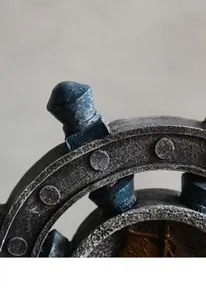 Macro view of vintage Mediterranean ship wheel detail with distressed paint finish