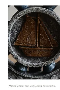 Macro detail of antique resin sailboat relief with vintage rough texture on ship wheel