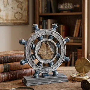 Vintage nautical ship wheel ornament with sailboat relief on rustic wooden desk