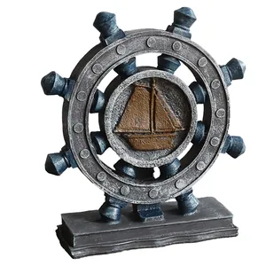 Mediterranean nautical ship wheel with sailboat relief and vintage bronze finish