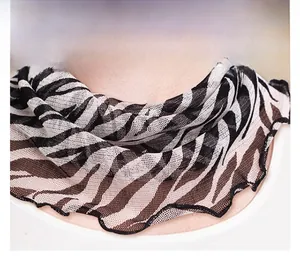 Detail view of zebra print silk neck gaiter with decorative lettuce edge trim