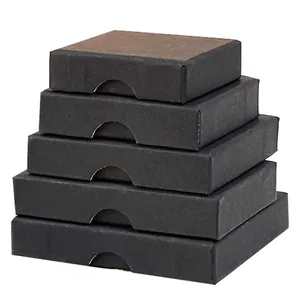 Stack of five matte black jewelry gift boxes in various sizes on white background