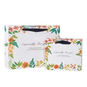 Set of two floral paper gift bags in medium and small sizes with black ribbon handles