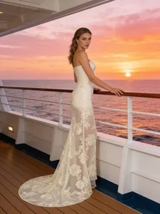 Elegant ivory strapless fishtail evening dress with lace embroidery on cruise deck