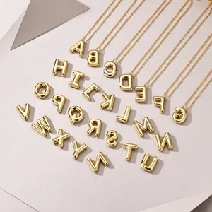 Macro detail of 26 alphabet 3D bubble pendants in gold plating with high mirror polish