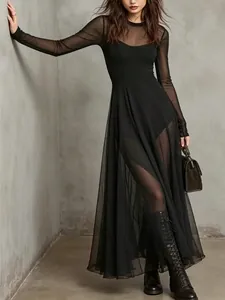 Detail view of the elegant black sheer mesh texture and layered long sleeve dress
