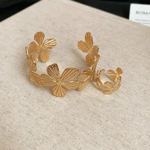Golden floral textured cuff bracelet and adjustable ring set with radial striped pattern