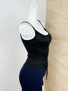 Side view detail of a slim fit black tank top with thin straps and elastic fabric texture