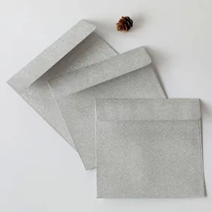 Close-up of square silver glitter envelopes with shimmering texture for invitations