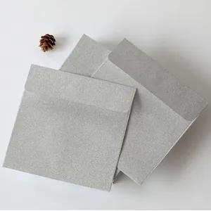 Macro detail of square silver glitter envelopes with elegant shimmering texture