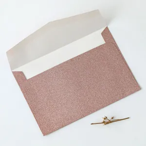 Detailed view of rose gold glitter envelope with pointed flap and shimmering texture