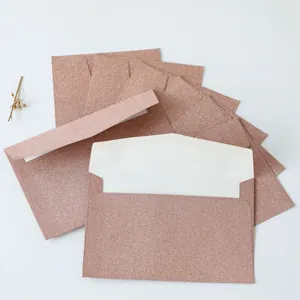 Close-up of glittery rose gold envelopes for elegant invitations and gift cards