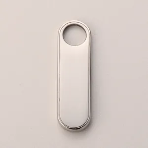 Macro view of polished silver oval stainless steel zipper pull with a top hole