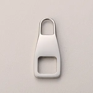 Macro shot of polished silver-tone 316 stainless steel zipper pull with square cutout