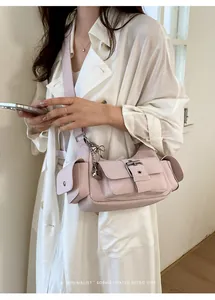 Detailed shot of a pale pink multi-pocket faux leather shoulder bag with silver chain