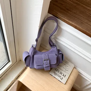 Close-up of lavender purple crossbody bag with multi-pocket design and metal buckles