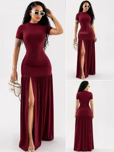 Detailed view of women's burgundy maxi dress with side slit and pleated texture