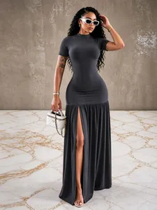 Detailed view of dark grey slim fit maxi dress with high slit and pleated skirt hem