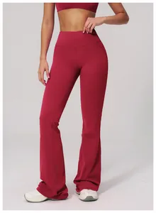 Detail view of high-waisted flared yoga pants in dark red with ergonomic cut for fitness