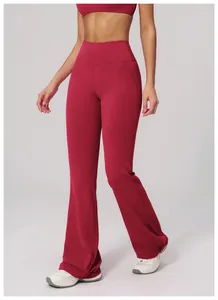 Detail of high-waist yoga flared leggings in burgundy with reinforced stitching